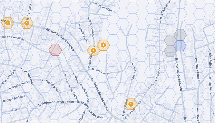 A street map of a neighbourhood divided into hexagonal cells. Several cells are outlined in orange with the number 1, one in red, and a cluster of grey and blue cells sits to the right.